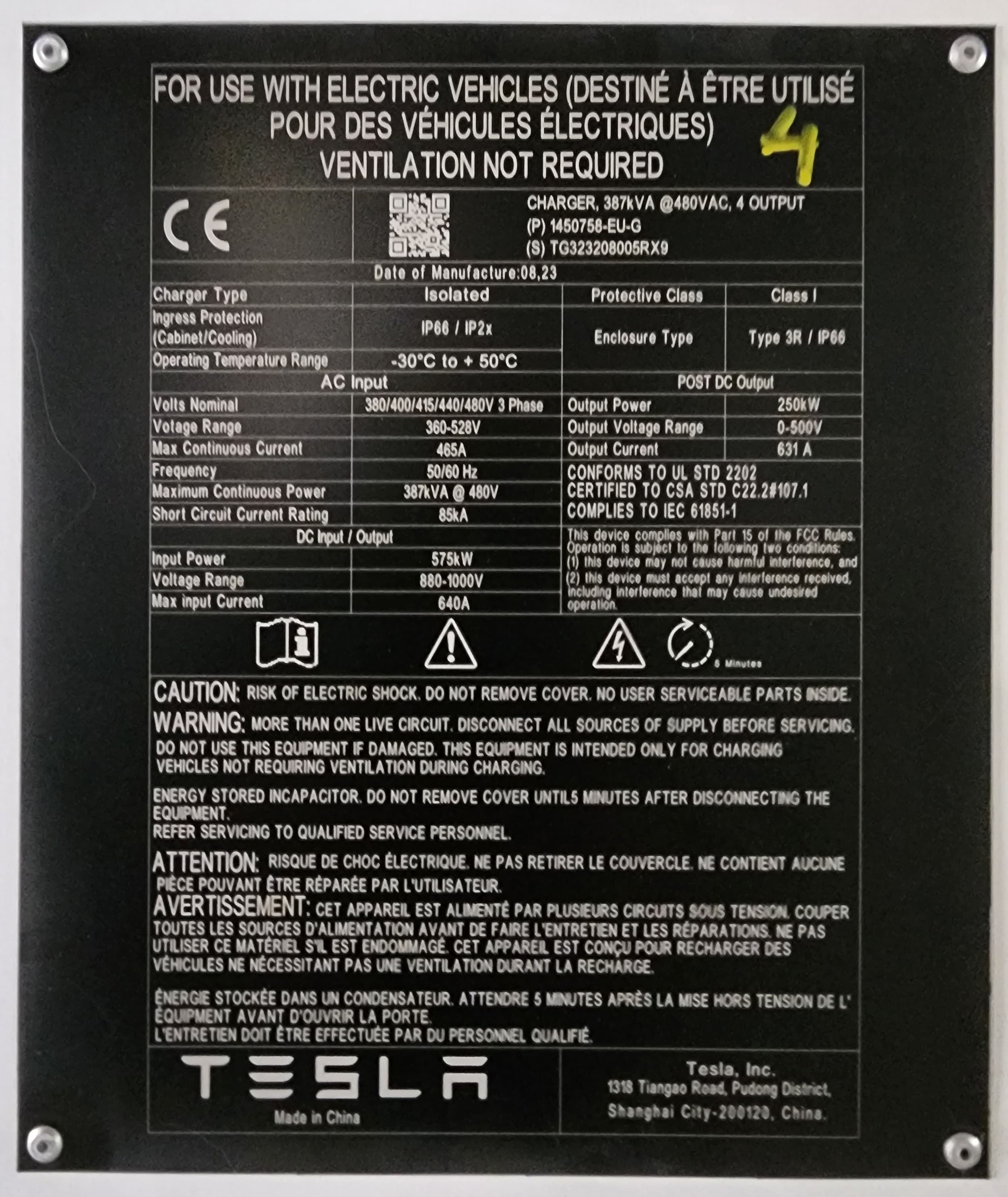 Tesla V4 Supercharger nameplate; the V4 generation adds on-post payments in many markets