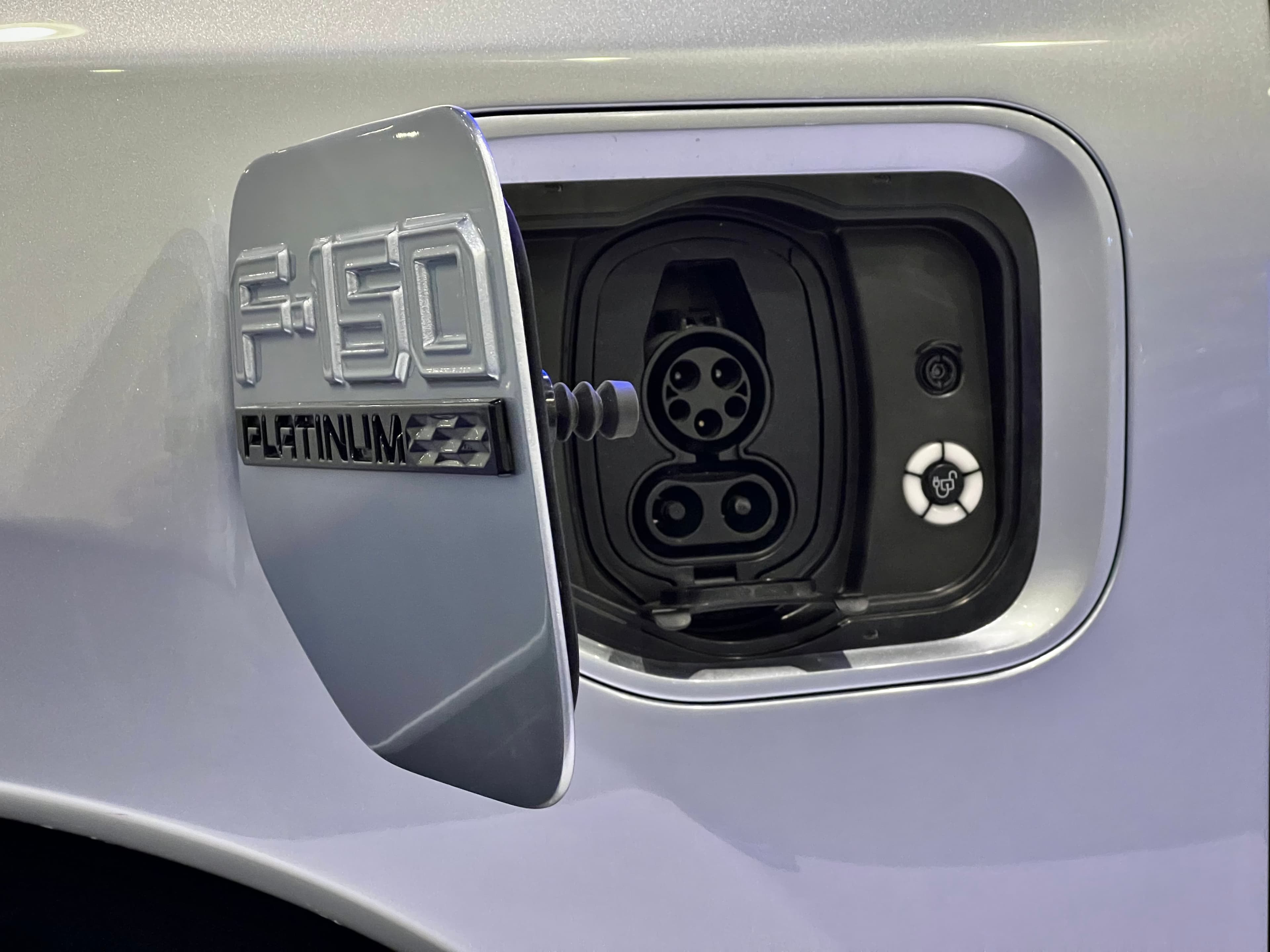 Close-up of a Ford F‑150 Lightning charge port open and ready.