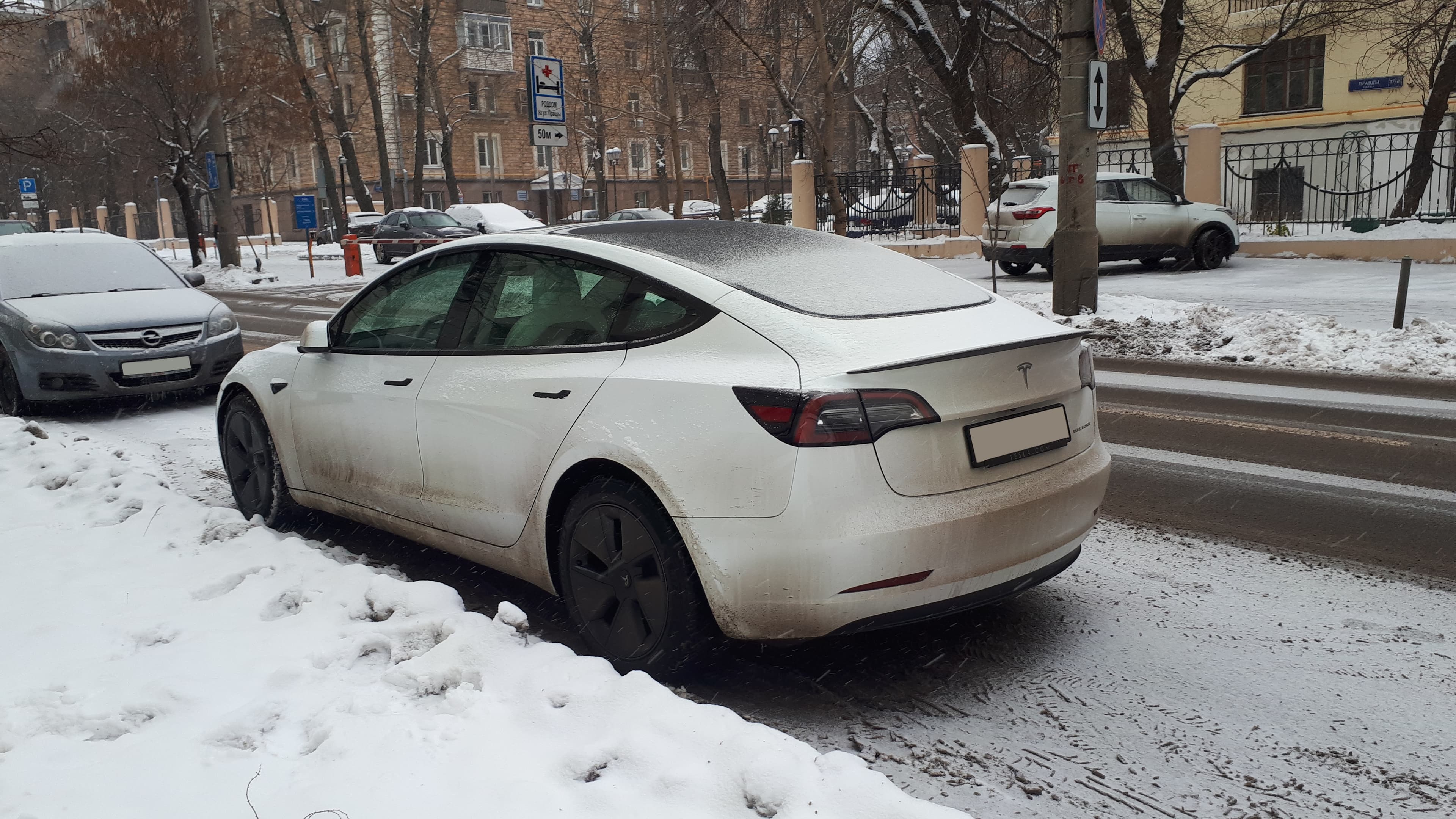 Tesla Model S on a snowy street, rear view