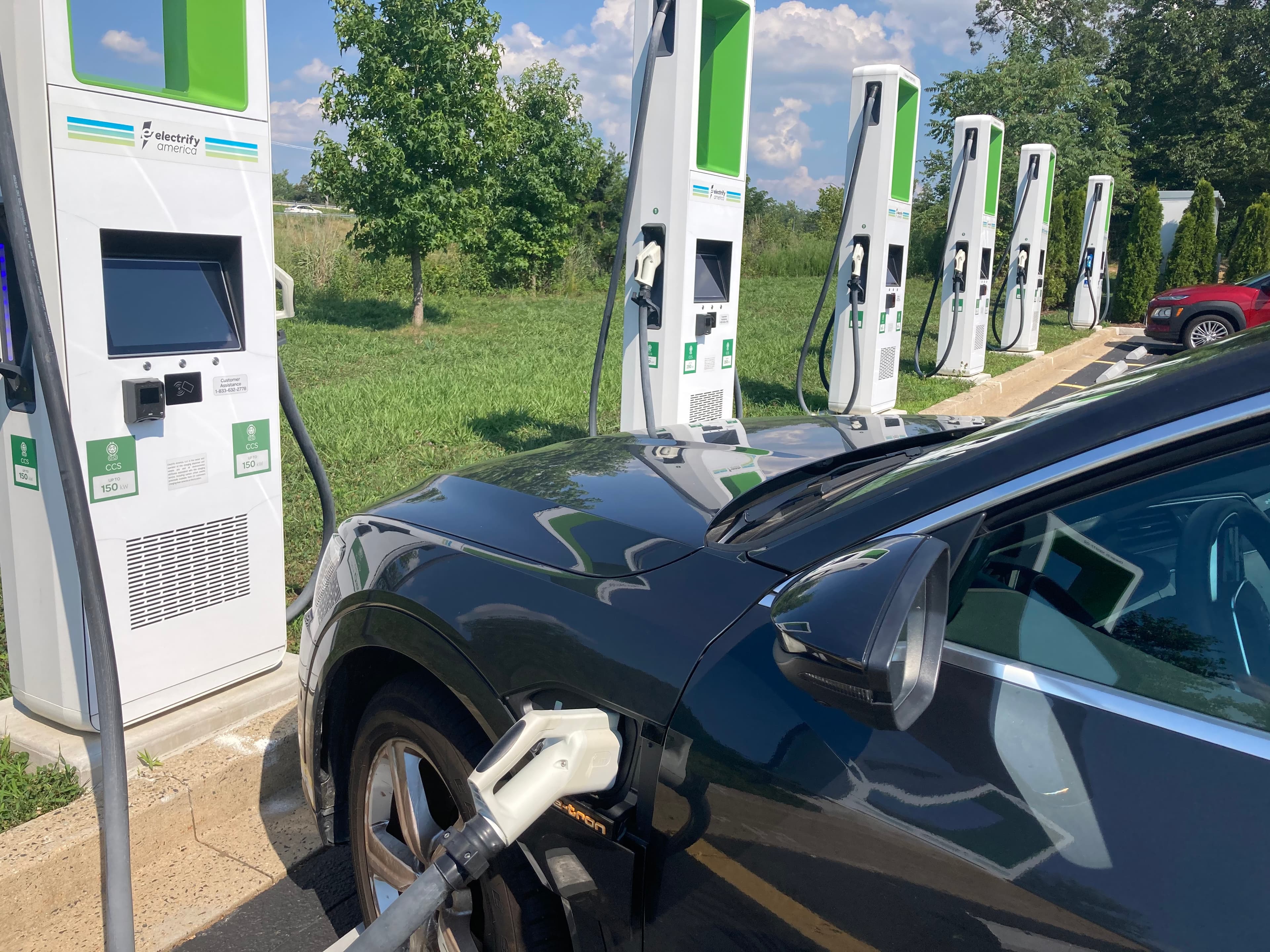 Row of DC fast chargers against evening sky