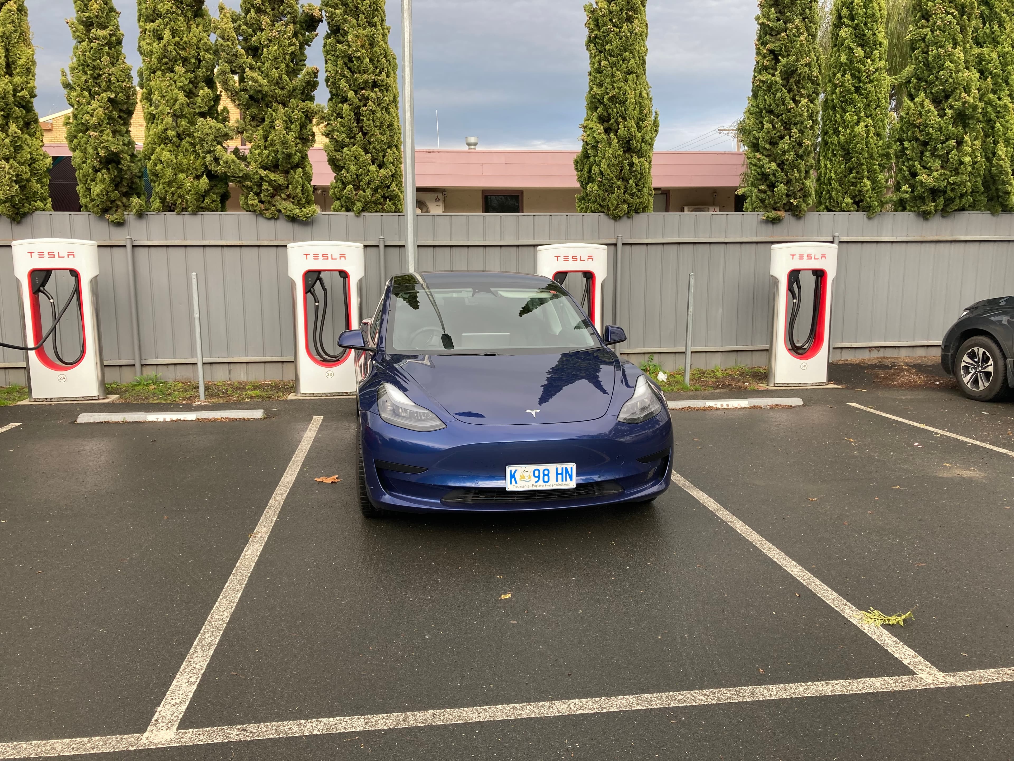 Tesla Model 3 charging at a Supercharger site